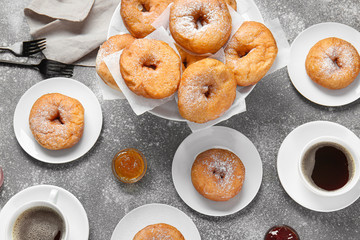 Sweet tasty donuts and coffee on grey background