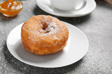Sweet tasty donut on grey background