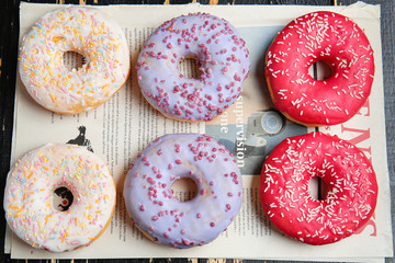 Sweet tasty donuts on table