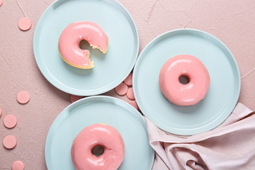 Sweet tasty donuts on color background