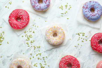 Sweet tasty donuts on table