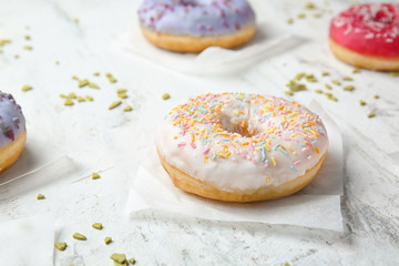 Fototapeta na wymiar Sweet tasty donuts on table