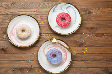 Sweet tasty donuts on table