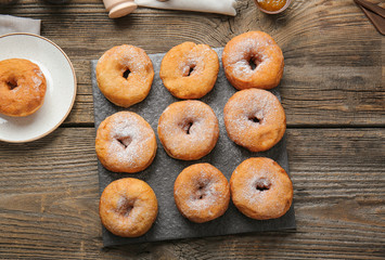 Sweet tasty donuts on table