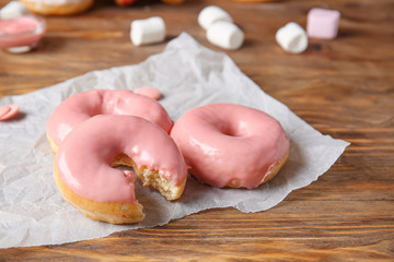 Sweet tasty donuts on table