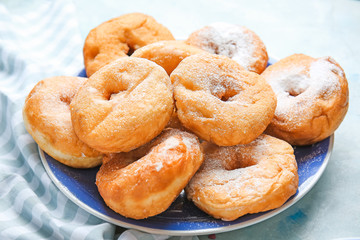 Sweet tasty donuts on table