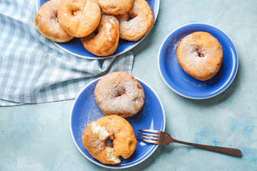 Sweet tasty donuts on table