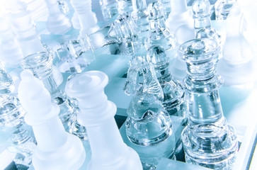 Chess game with transparent glass figures in wintery icy atmosphere