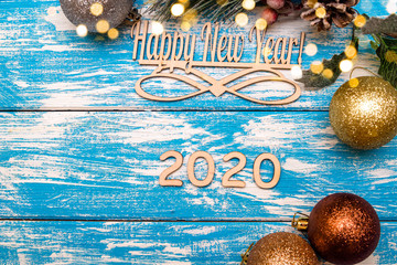 Happy new year 2020 on wooden blue background.
