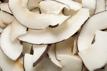Fresh delicious coconut chips as background, closeup