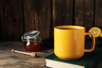 Delicious tea with honey on wooden table