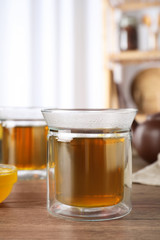 Cup of delicious tea on wooden table