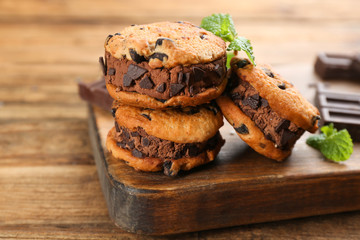 Sweet delicious ice cream cookie sandwiches on wooden table