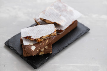 turron on dark board on ceramic background