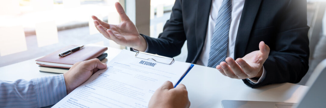Interview the job and hiring, men candidate at job interview explaining about his profile to business manager in modern office space. Business consulting or employment concept.