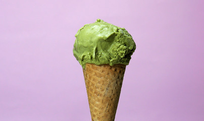 Green Tea Flavoured Ice Cream in waffle cone isolated on pink background, Closeup Front view Food...
