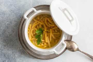 Passatelli in brodo - passatelli in broth - pasta cooked in chicken broth. A pasta formed of bread crumbs, eggs, grated Parmesan cheese. Typical for Pesaro, Urbino and Emilia  Romagna.