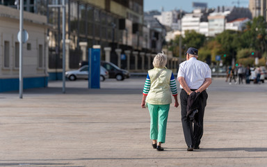 Elderly couple taking a walk in the city
