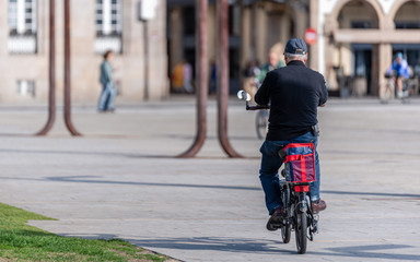 Middle age male riding  electric bicycle