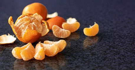 Mandarin oranges flatlay on dark background, citrus composition with copy space