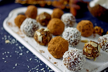 Raw food dessert balls made of dates and nuts. Homemade sweets without sugar and gluten, proper nutrition, vegan sweets