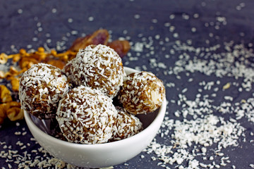 Homemade sweets. Useful sweets in the form of balls of nuts, dates, coconut and dried fruits. The concept of vegan desserts and sweets without sugar.