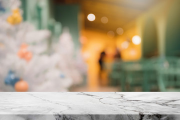 Empty white mable stone table top on blur with bokeh Christmas tree and new's year decoration on window background - can be used for display or montage your products.
