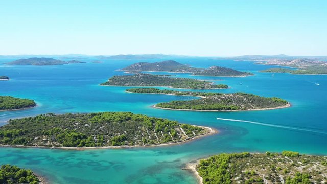 Emerald and turquoise blue sea, many small green islands in Murter archipelago from air, Dalmatia, Croatia. Seascape paradise. Drone reveal footage.