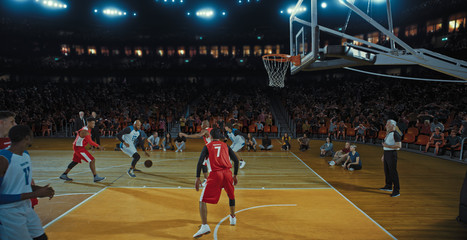 Fototapeta premium Basketball players on big professional arena during the game. Tense moment of the game. Celebration