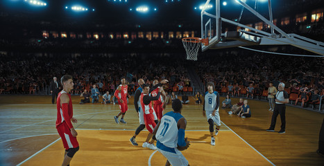 Basketball players on big professional arena during the game. Tense moment of the game. Celebration