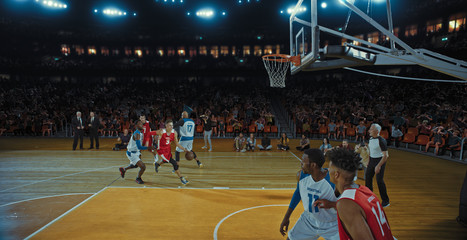 Fototapeta premium Basketball players on big professional arena during the game. Tense moment of the game. Celebration