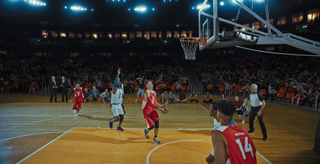 Basketball players on big professional arena during the game. Tense moment of the game. Celebration