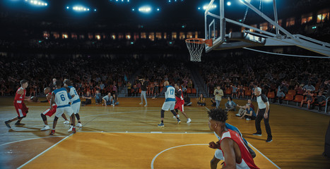 Fototapeta premium Basketball players on big professional arena during the game. Tense moment of the game. Celebration