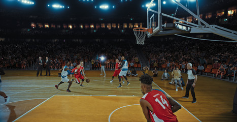 Fototapeta premium Basketball players on big professional arena during the game. Tense moment of the game. Celebration