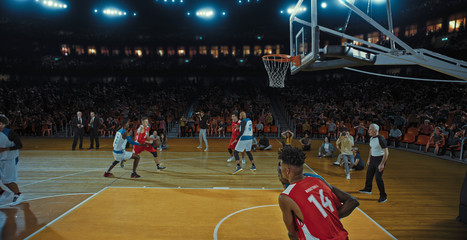 Fototapeta premium Basketball players on big professional arena during the game. Tense moment of the game. Celebration
