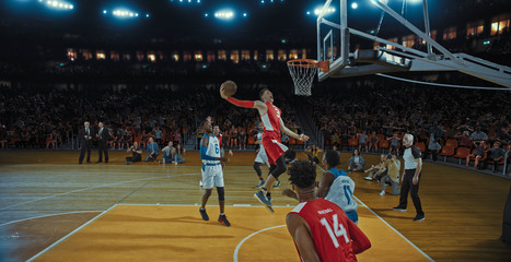 Basketball players on big professional arena during the game. Tense moment of the game. Celebration
