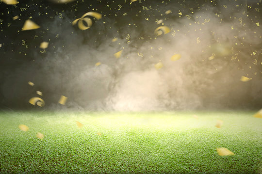 Green grass with smoke and flying golden confetti