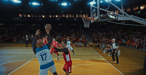 Fototapeta premium Basketball players on big professional arena during the game. Tense moment of the game. Celebration