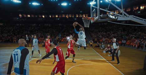 Basketball players on big professional arena during the game. Tense moment of the game. Celebration