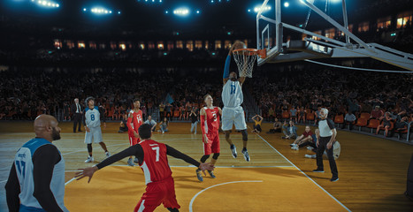Basketball players on big professional arena during the game. Tense moment of the game. Celebration