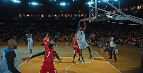 Basketball players on big professional arena during the game. Tense moment of the game. Celebration