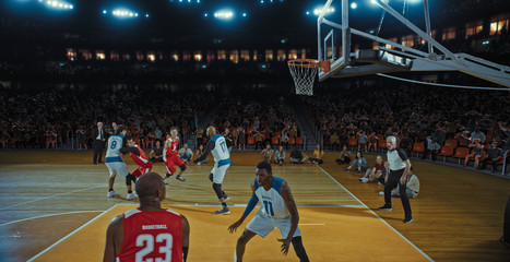 Basketball players on big professional arena during the game. Tense moment of the game. Celebration © haizon