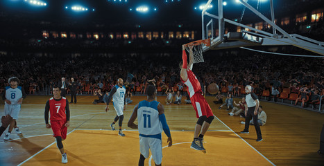 Basketball players on big professional arena during the game. Tense moment of the game. Celebration