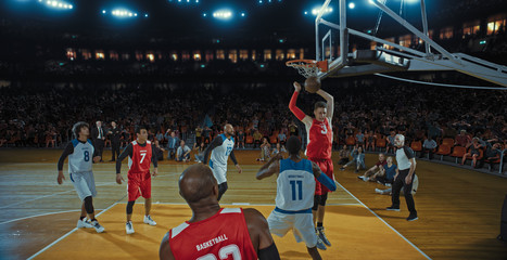 Basketball players on big professional arena during the game. Tense moment of the game. Celebration