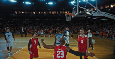 Fototapeta premium Basketball players on big professional arena during the game. Tense moment of the game. Celebration