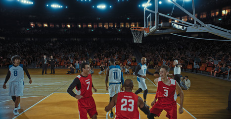Fototapeta premium Basketball players on big professional arena during the game. Tense moment of the game. Celebration