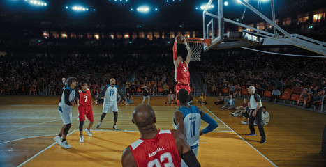 Basketball players on big professional arena during the game. Tense moment of the game. Celebration