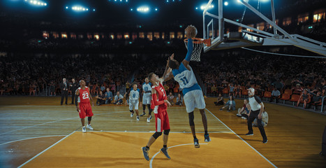 Basketball players on big professional arena during the game. Tense moment of the game. Celebration