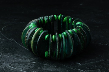 Natural green stone bracelet on a dark background close-up