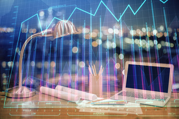 Forex market graph hologram and personal computer on background. Double exposure. Concept of investment.